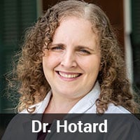 A woman with curly hair and a white coat smiles at the camera. The text "Dr. Hotard, Veterinarian" is displayed at the bottom of the image.